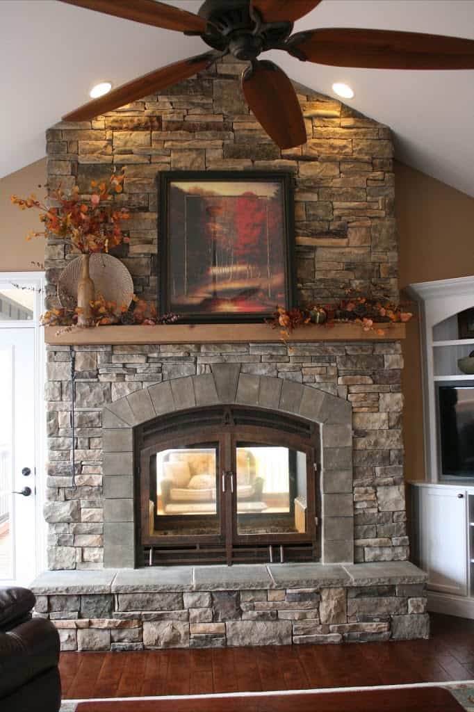 traditional stone double sided fireplace