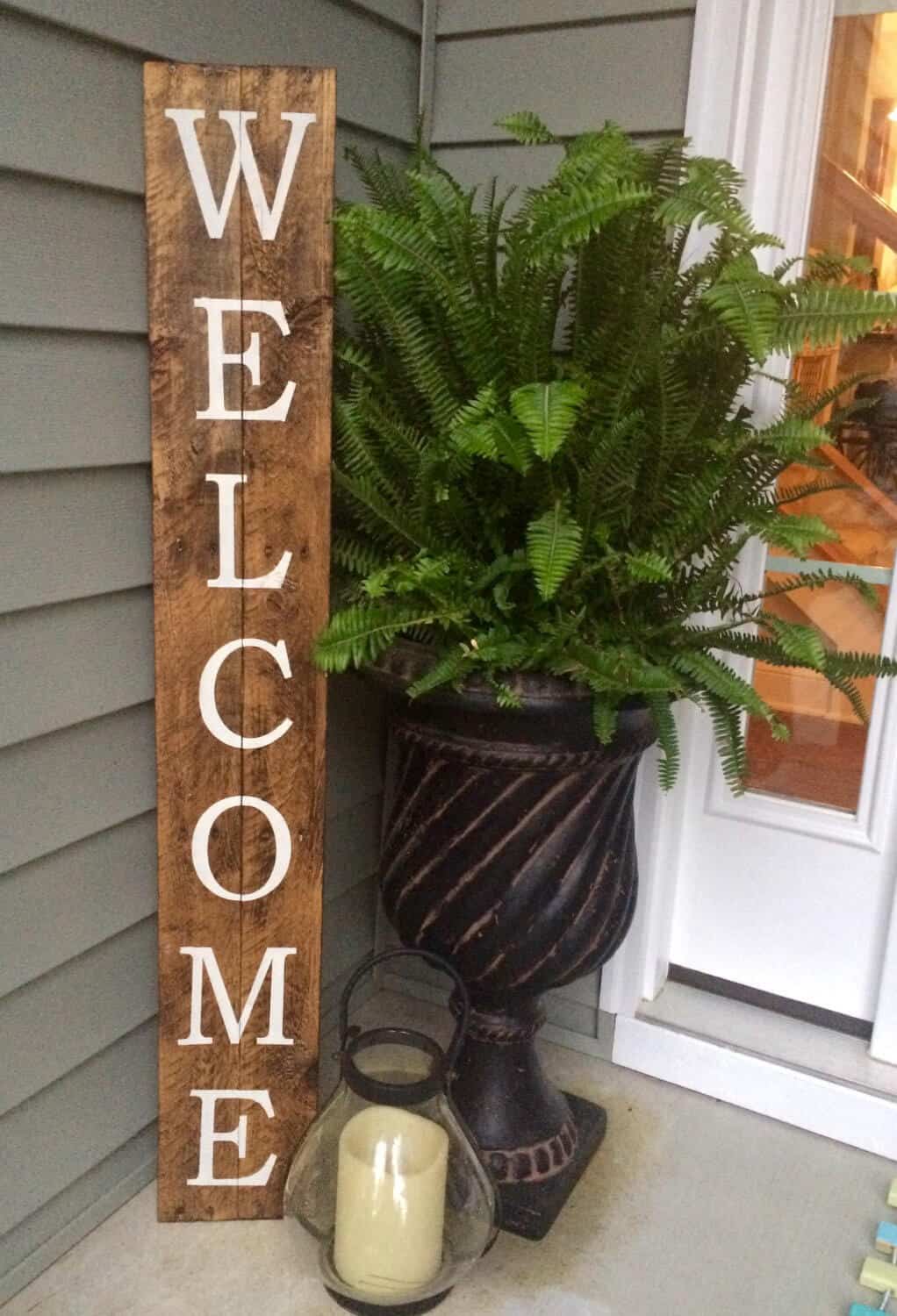 A simple welcome sign on a piece of wood can make a huge difference in the appearance of your porch