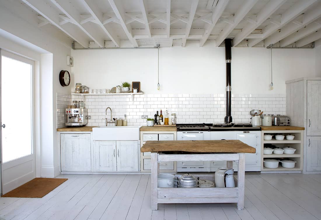 An all-white kitchen can be rustic the key is adding a country feel to it for that classic charm.