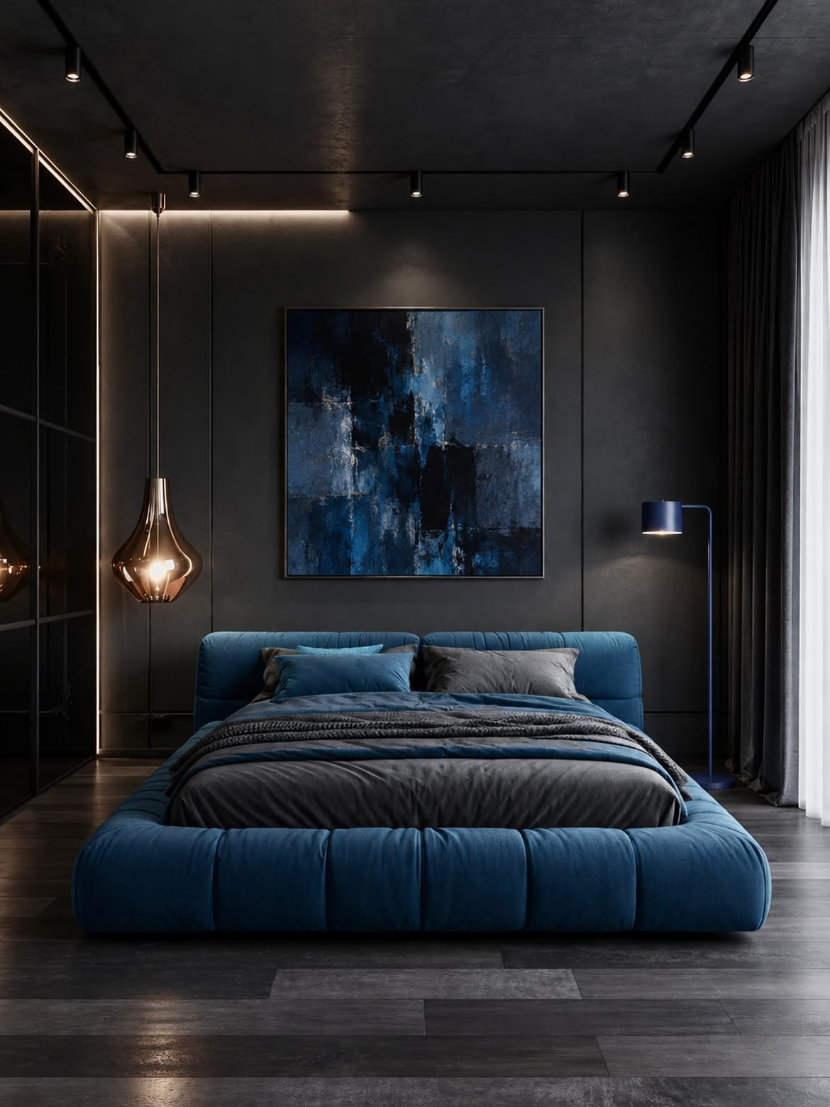 A blue tufted platform bed against a dark gray wall with large blue abstract art, copper pendant, and cobalt floor lamp.