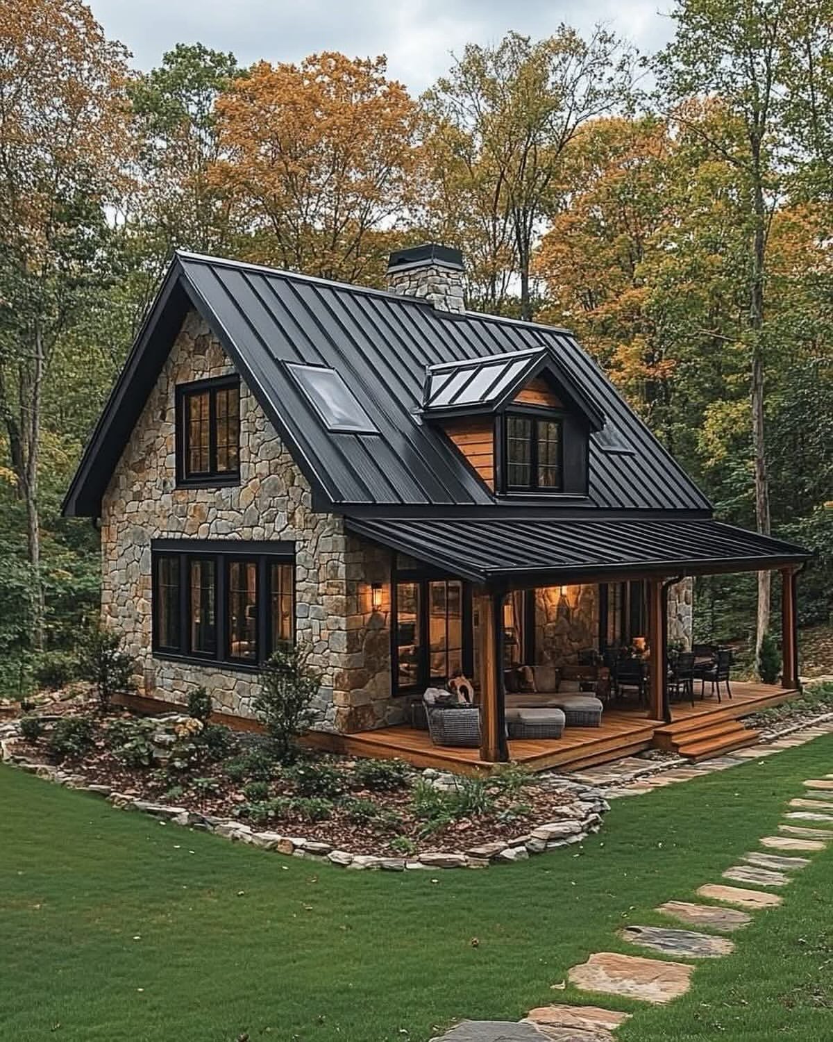 02-stone-cottage-black-metal-roof-covered-porch-autumn-woods