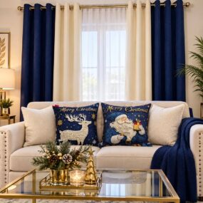 A navy and gold Christmas living room with a decorated tree, cream sectional with bow pillows, velvet drapes, and a round marble coffee table centerpiece.