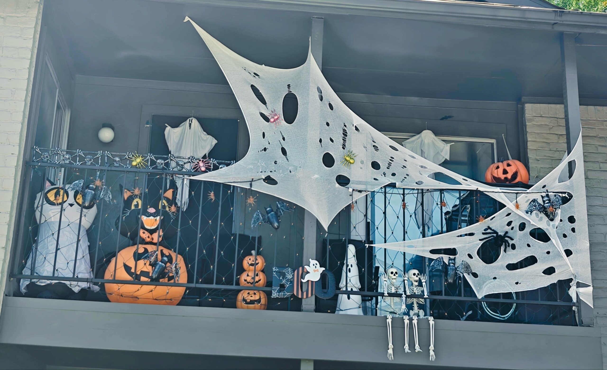 4-daytime-balcony-oversized-spiderweb-jack-o-lanterns
