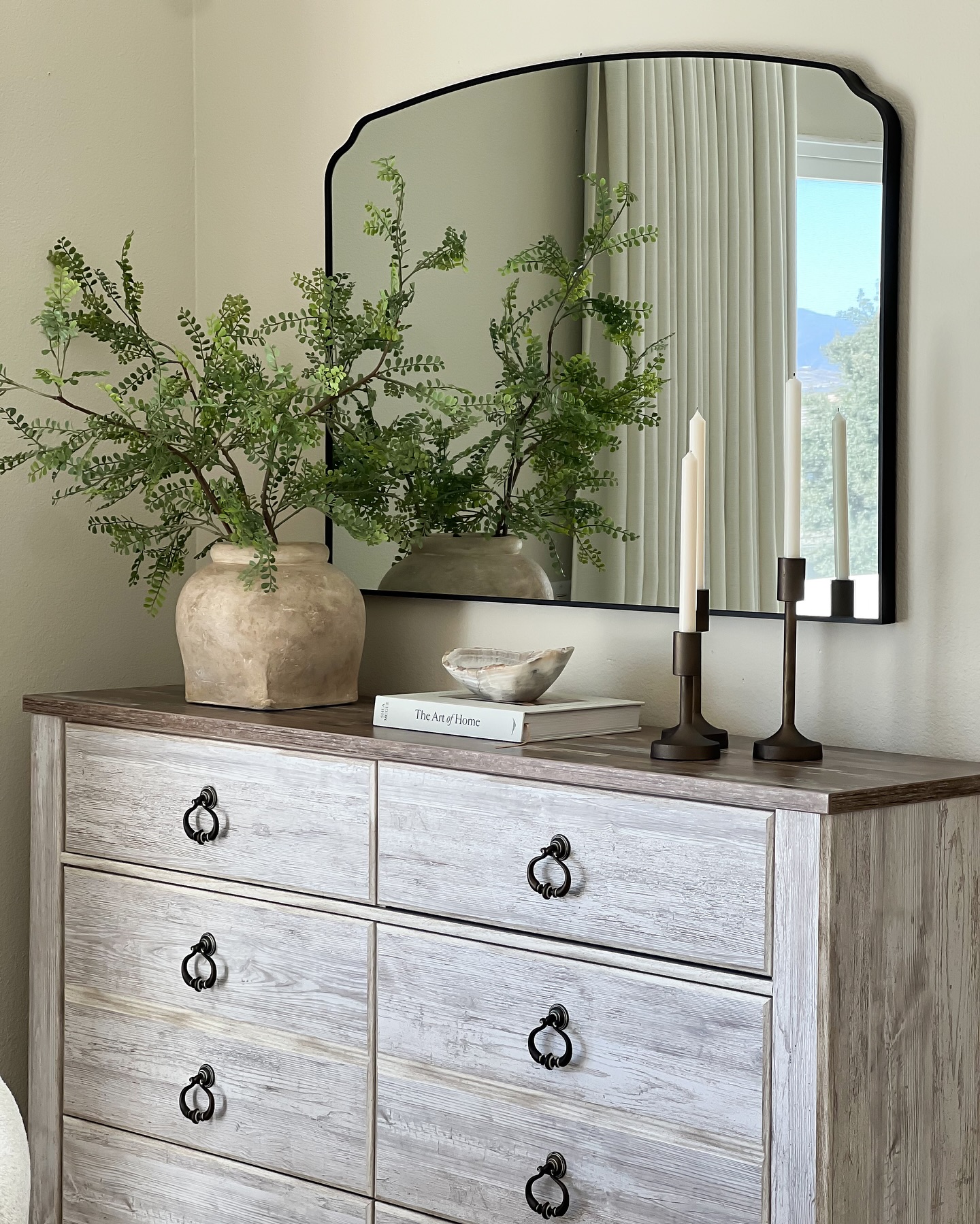 arched-mirror-greenery-candlesticks-dresser-decor