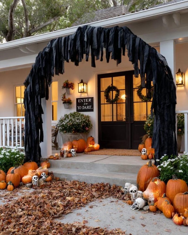 black-draped-entry-arch-with-pumpkin-rows-halloween-porch