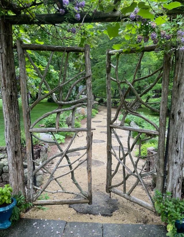 curved-gray-wood-gate-with-stone-walls-marthabaker