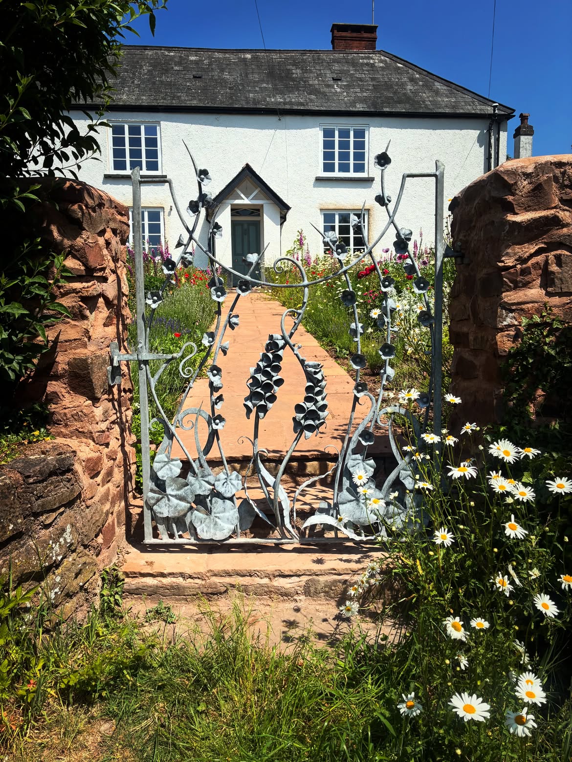 hand-forged-floral-iron-gate-with-wildflower-cottage-simonconnettblacksmith
