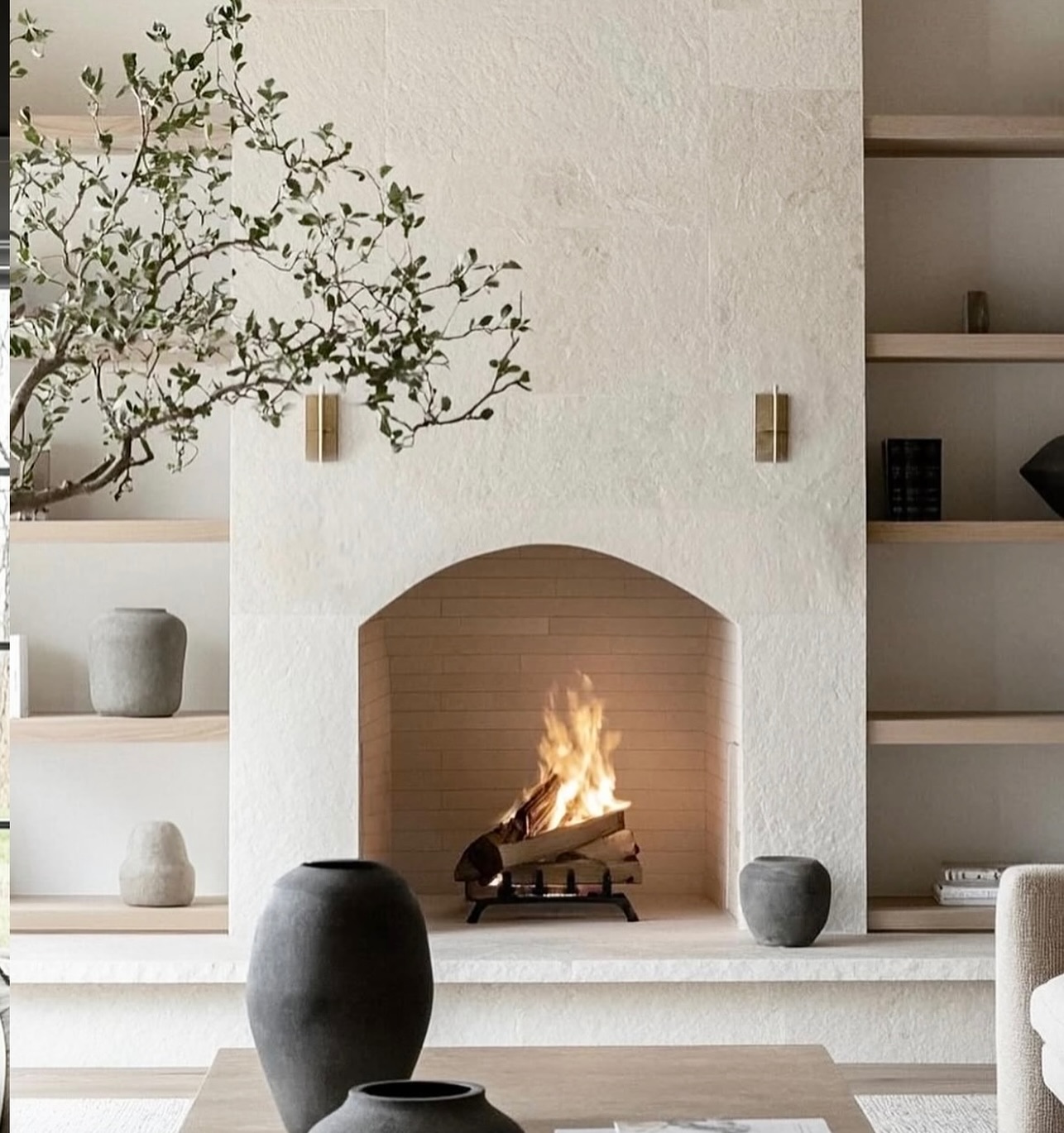 limestone-arched-fireplace-with-shelves