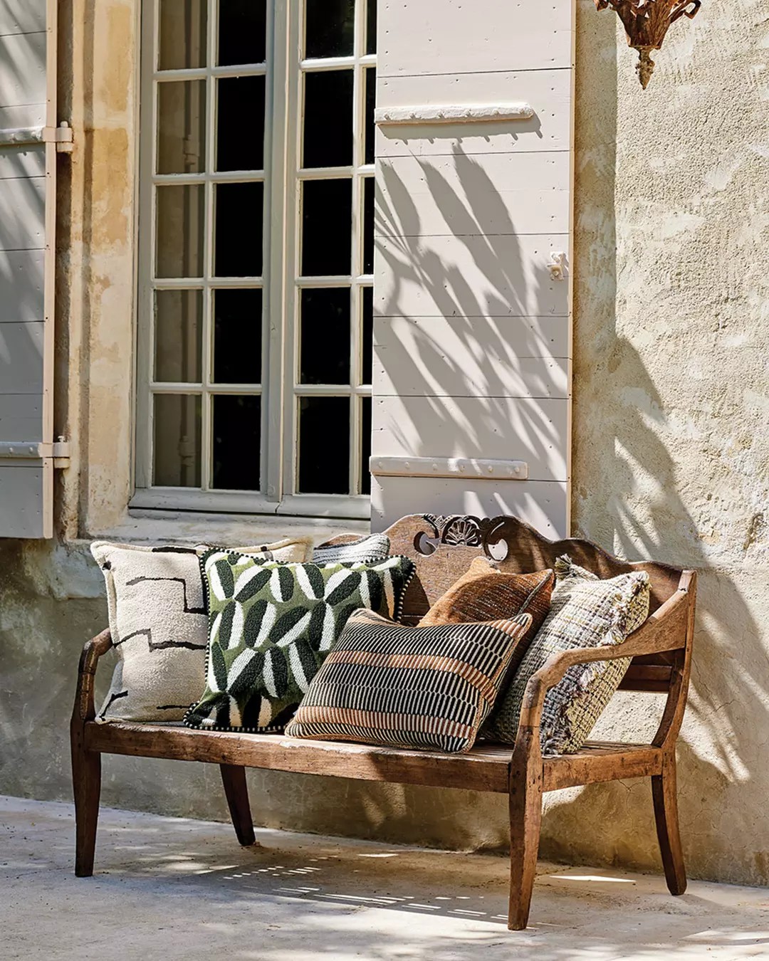 olive-green-cream-botanical-cushions-rustic-wood-bench-provencal-shutters