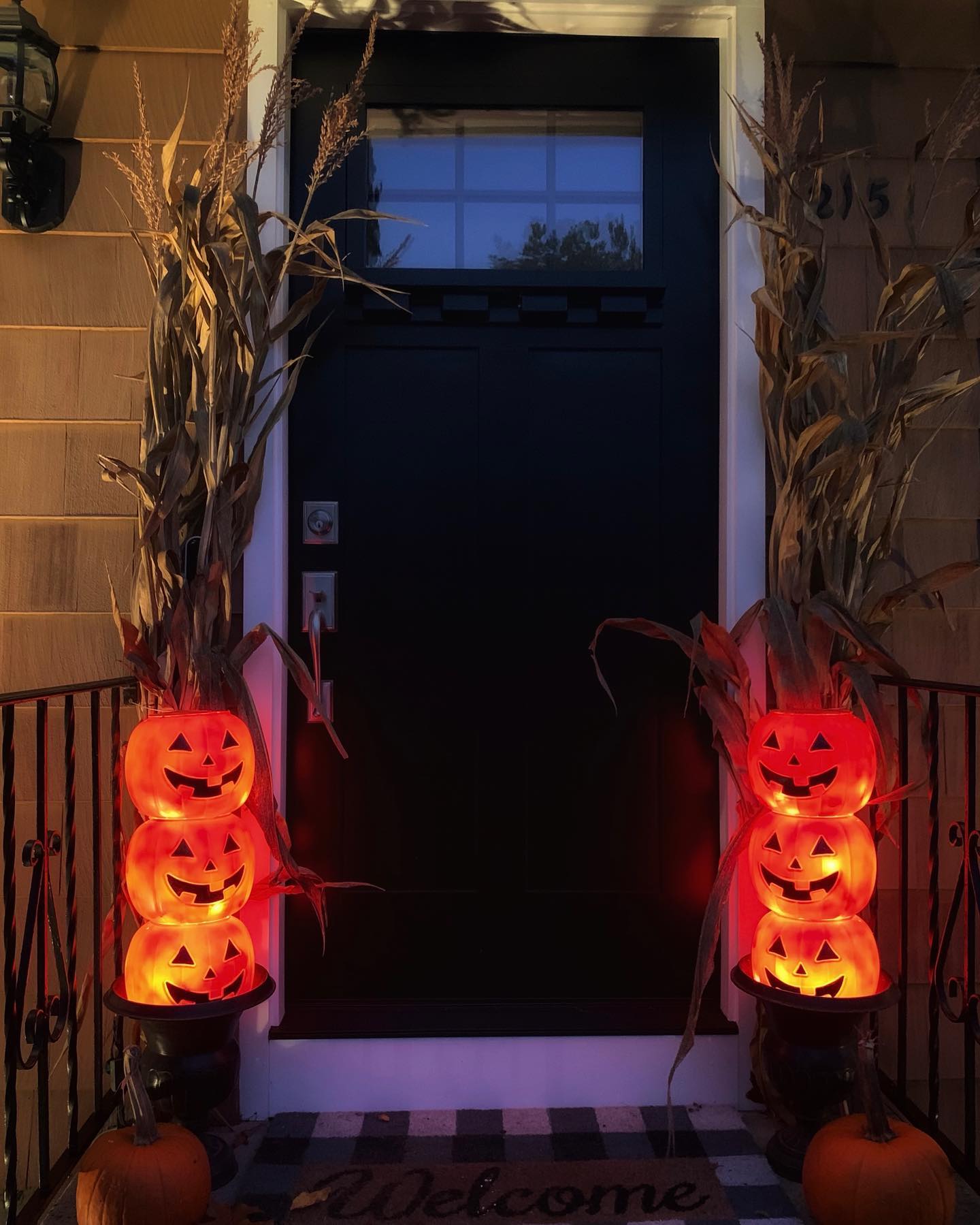 stacked-pumpkin-pails-corn-stalks-porch