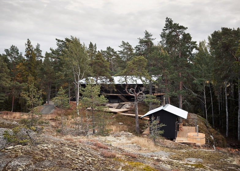 single storey summer house overlooks forested gorge sweden 1