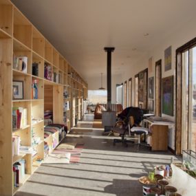 Nakai House in Utah Features Wall of Shelves with Bedroom Niche