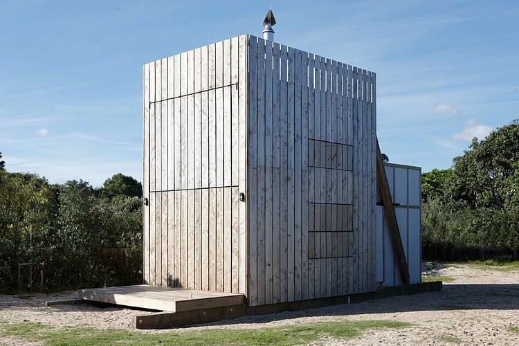 transportable sustainable beach hut rests 2 wooden sleds 2 windows closed