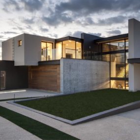 Geometric Concrete and Steel Home with Stone and Water Elements