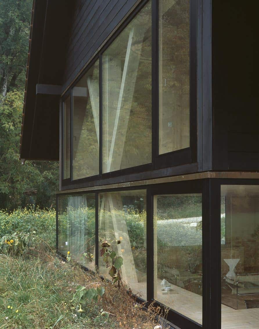 barn home floats round window over lower facade glass 25 windows