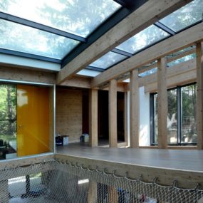Energy Efficient Forest Home has Suspended Net Lounge