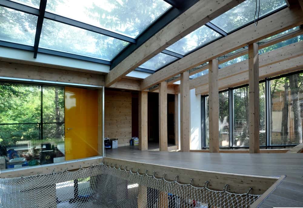 Energy Efficient Forest Home has Suspended Net Lounge