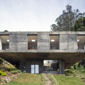 This Fascinating Square Concrete House Sits on a Small Pedestal