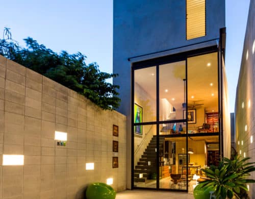Skinny Concrete Home with Double Height Glass Doors