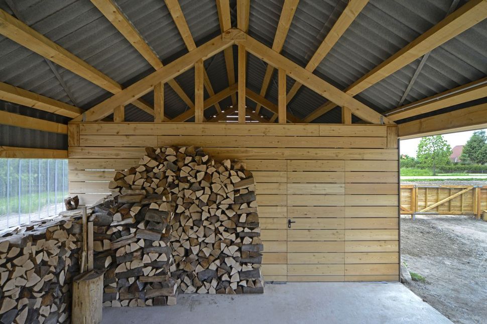 modern-open-concept-homestead-centralcourtyard-germany-13-woodshed.jpg