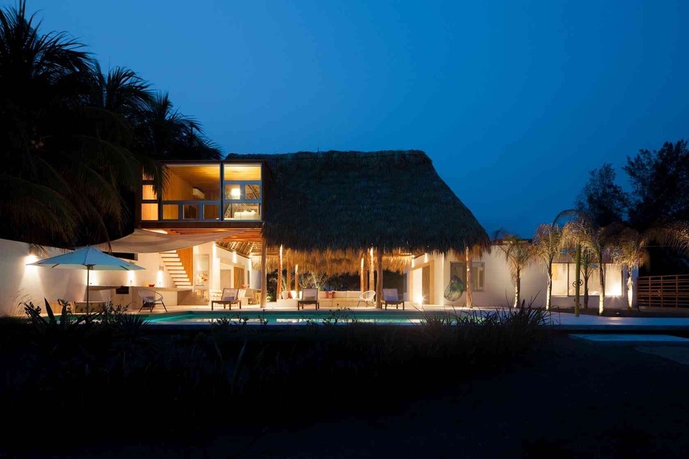 colorful-tropical-open-home-rough-cut-thatched-roof-2-main-view-night.jpg