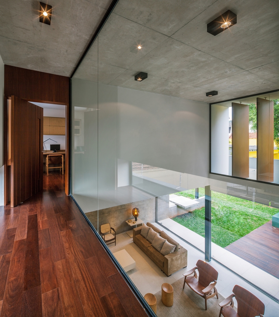 dual-direction-concrete-home-surrounds-poolside-courtyard-brazil-9-glass-mezzanine.jpg