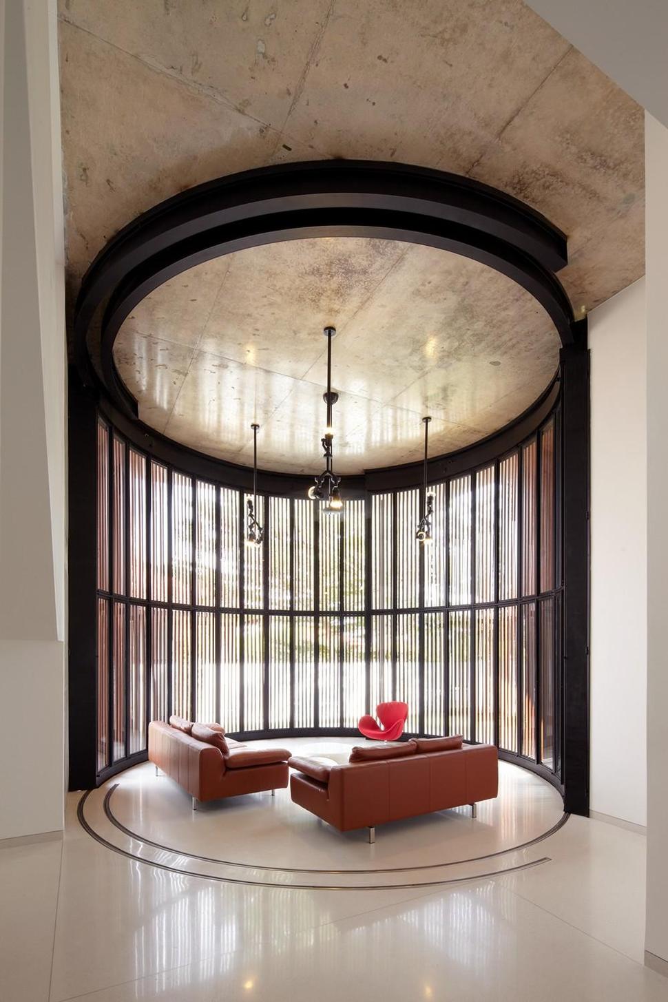 curved-stacking-glass-doors-surround-drum-shaped-room-voila-house-23-drum-closed.jpg