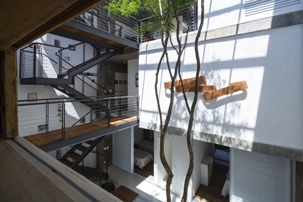 brazilian-concrete-house-built-around-three-story-courtyard-tree-12-second-level-courtyard-overlook.jpg