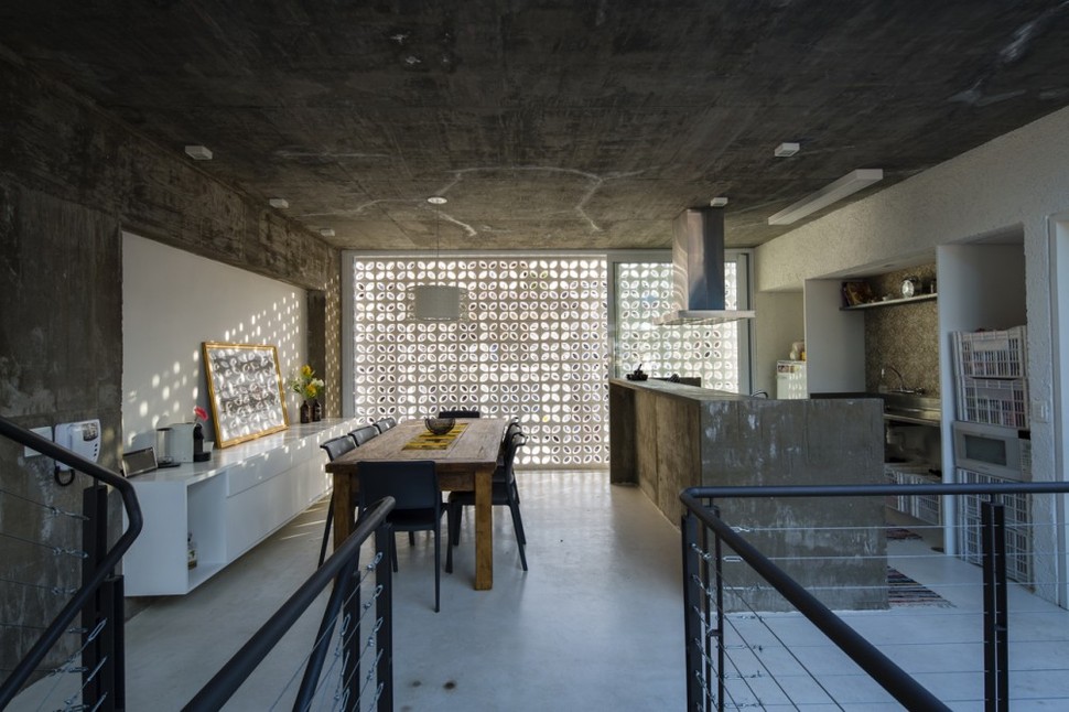 brazilian-concrete-house-built-around-three-story-courtyard-tree-15-into-kitchen.jpg