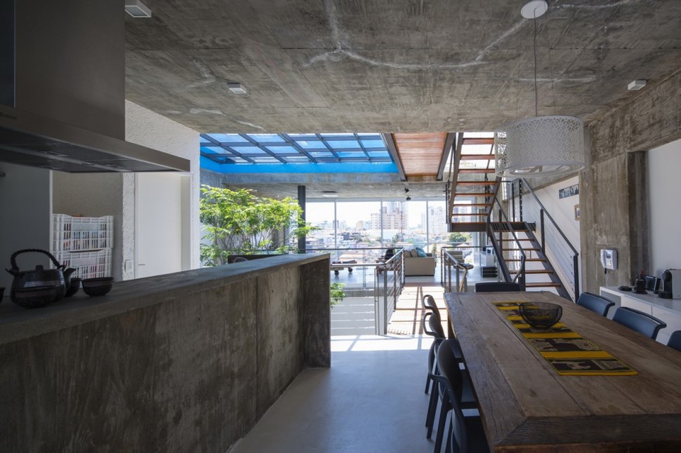 brazilian-concrete-house-built-around-three-story-courtyard-tree-16-kitchen-view-out.jpg