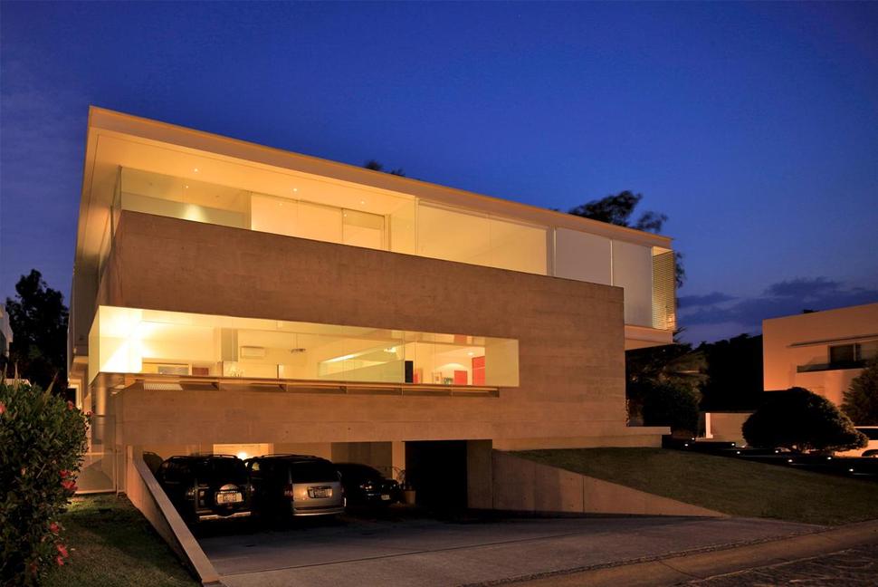 geometric-home-cantilevered-master-suite-overlooking-pool-17-garage-evening.jpg