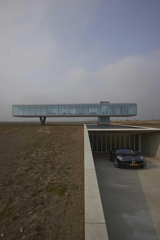 striking-minimal-glass-house-elevated-above-barren-landscape-3-far-day.jpg