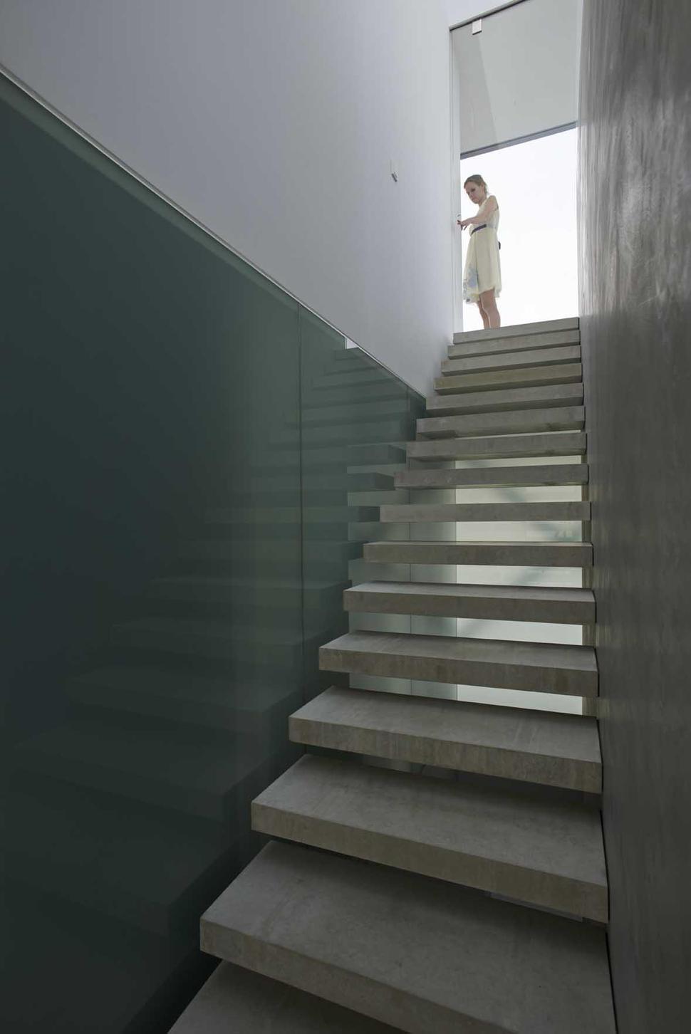 striking-minimal-glass-house-elevated-above-barren-landscape-5-staircase-inside.jpg