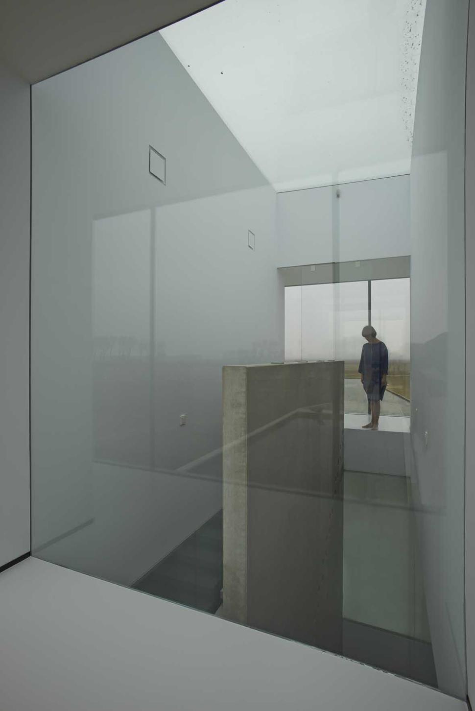 striking-minimal-glass-house-elevated-above-barren-landscape-6-staircase-outside.jpg