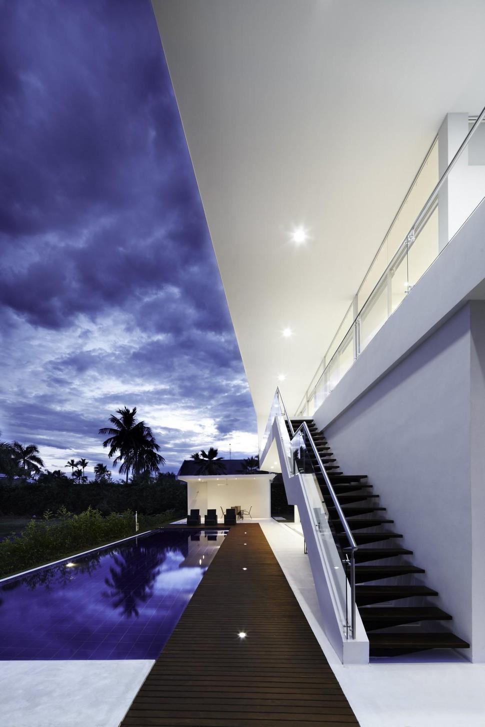 white-home-for-two-families-with-indoor-outdoor-downstairs-3-pool-path-stairway.jpg