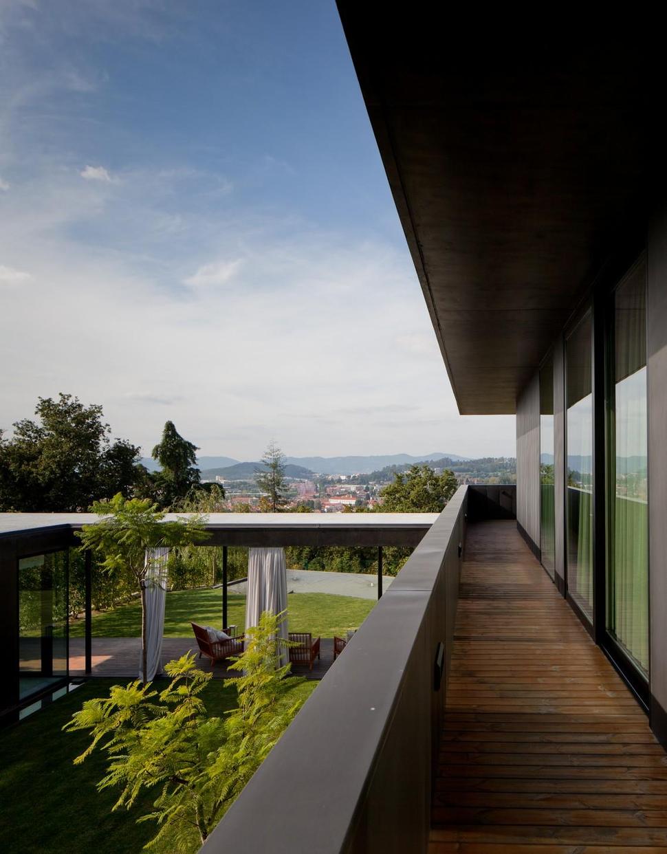 black-home-with-bright-interior-built-into-grassy-hillside-11-inside-upper-deck.jpg