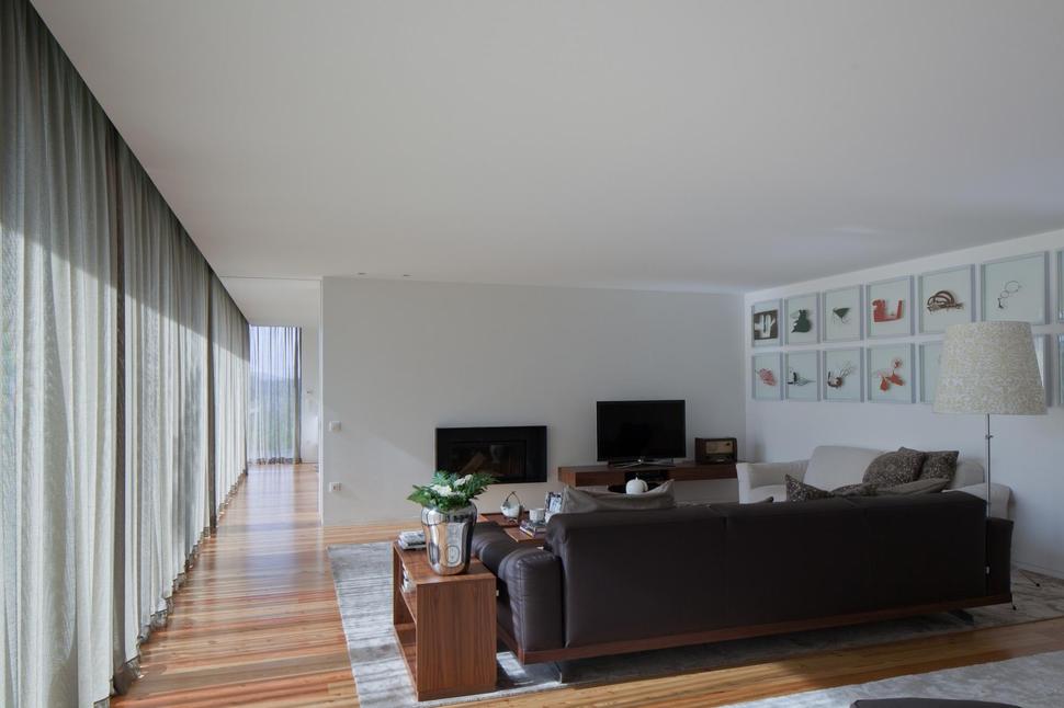 black-home-with-bright-interior-built-into-grassy-hillside-20-living-room.jpg