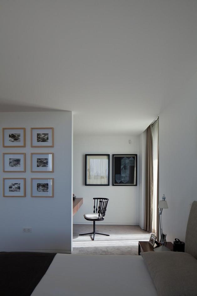 black-home-with-bright-interior-built-into-grassy-hillside-25-bedroom.jpg