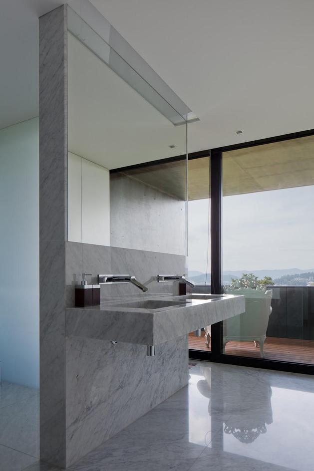 black-home-with-bright-interior-built-into-grassy-hillside-26-master-bathroom.jpg
