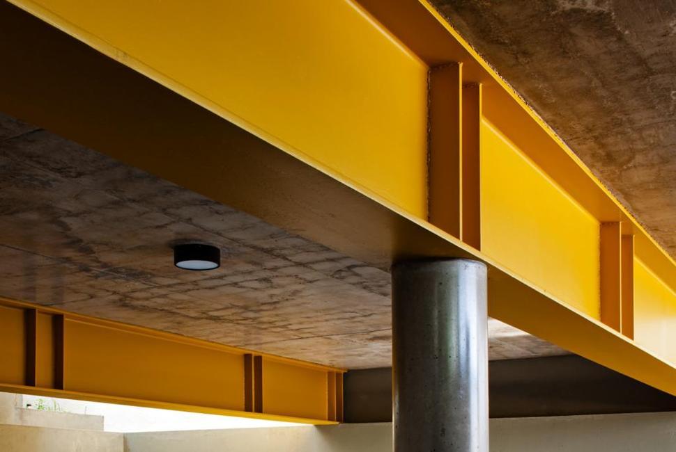 concrete-cube-home-supported-2-yellow-i-beams-4-garage-beams.jpg