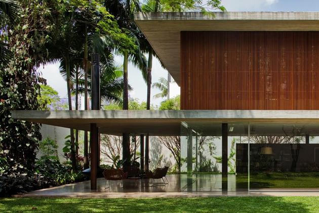 long-glass-house-with-folding-wooden-facade-3-patio-overhang.jpg