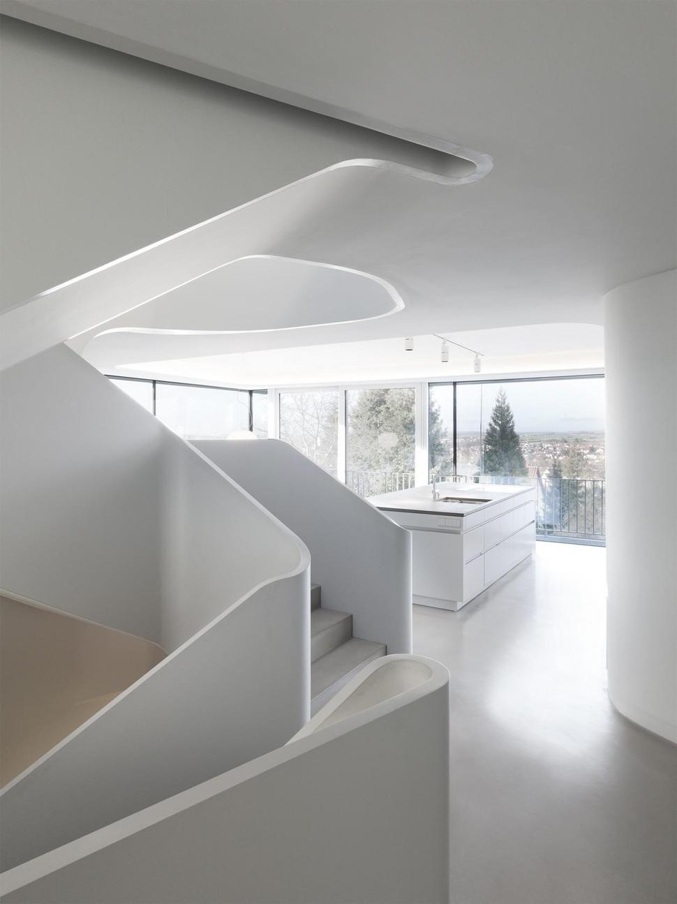 angular-modern-home-features-large-curvaceous-stairwell-inside-12-kitchen.jpg