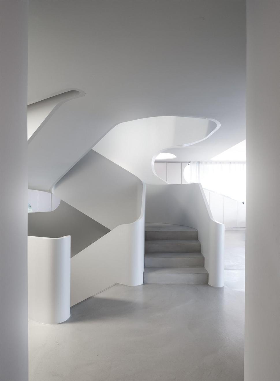 angular-modern-home-features-large-curvaceous-stairwell-inside-7-stairs.jpg
