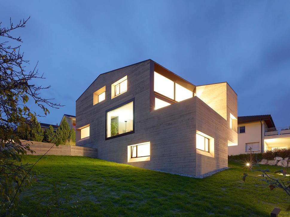 hillside-house-with-wood-look-concrete-covering-3-rear-left-evening-angle.jpg