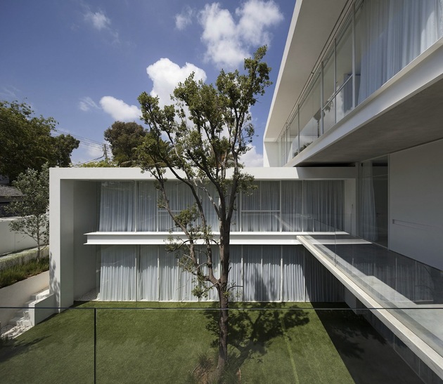 minimal-house-with-hangar-style-rear-facade-3-front-sideways-deck.jpg