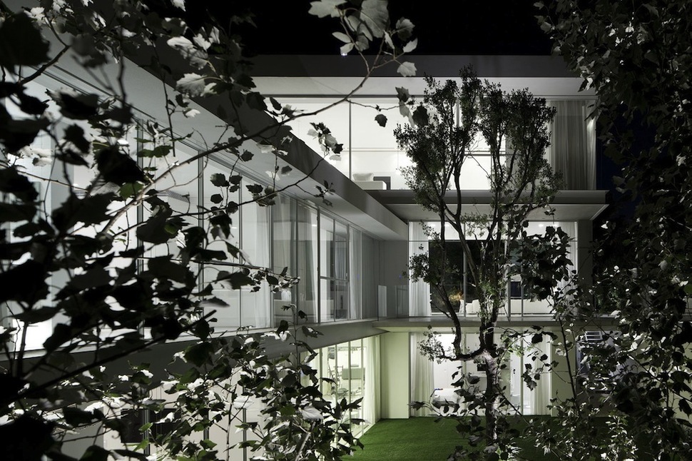 minimal-house-with-hangar-style-rear-facade-8-through-trees.jpg
