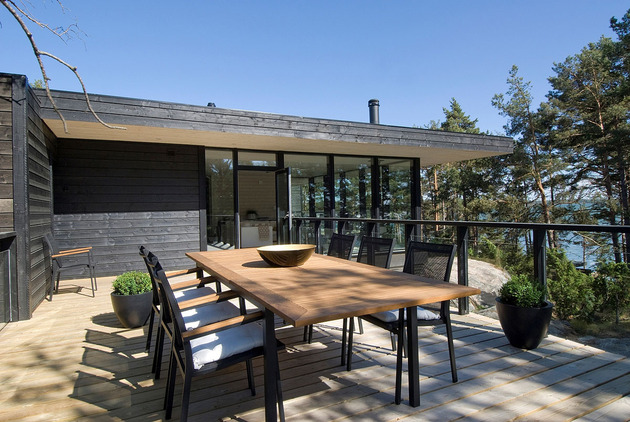 modern-wooden-vacation-house-built-on-rocks-3-outdoor-dining.jpg