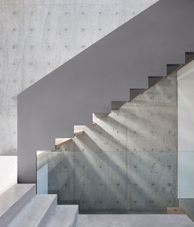 sleek-slope-house-with-interior-featuring-concrete-12-stairs-side.jpg