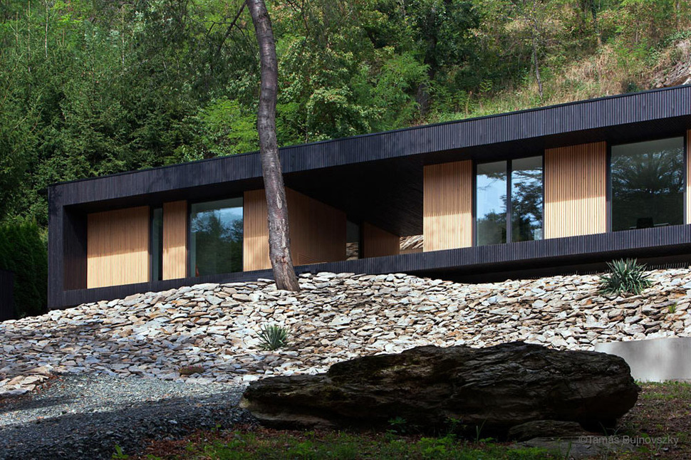 timber-cabin-built-into-cliff-side-site-2.jpg