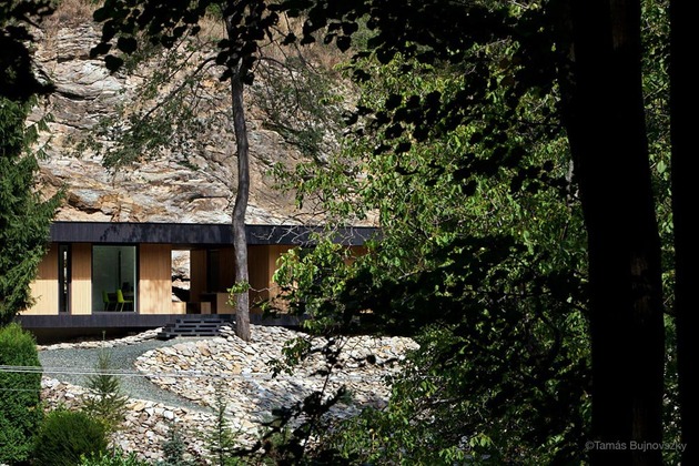 timber-cabin-built-into-cliff-side-site-3.jpg